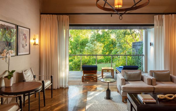 Deluxe lodge living room leading onto terrace overlooking gardens. at Delaire Graff Estate