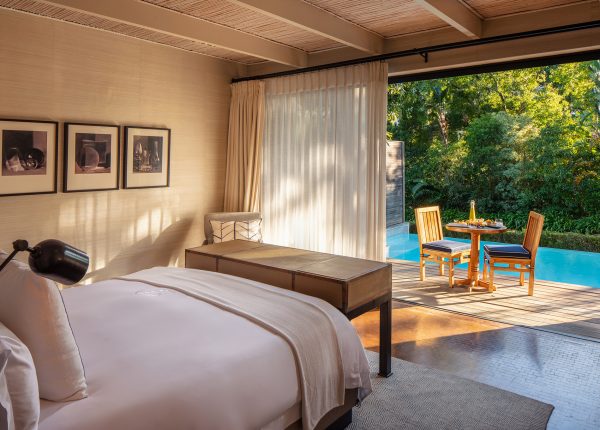 Deluxe Lodge king size bedroom leading onto terrace with private plunge pool overlooking Delaire Graff Estate gardens