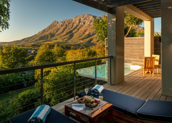 Luxury Lodge terrace and pool overlooking mountain and Delaire Graff Estate vineyards