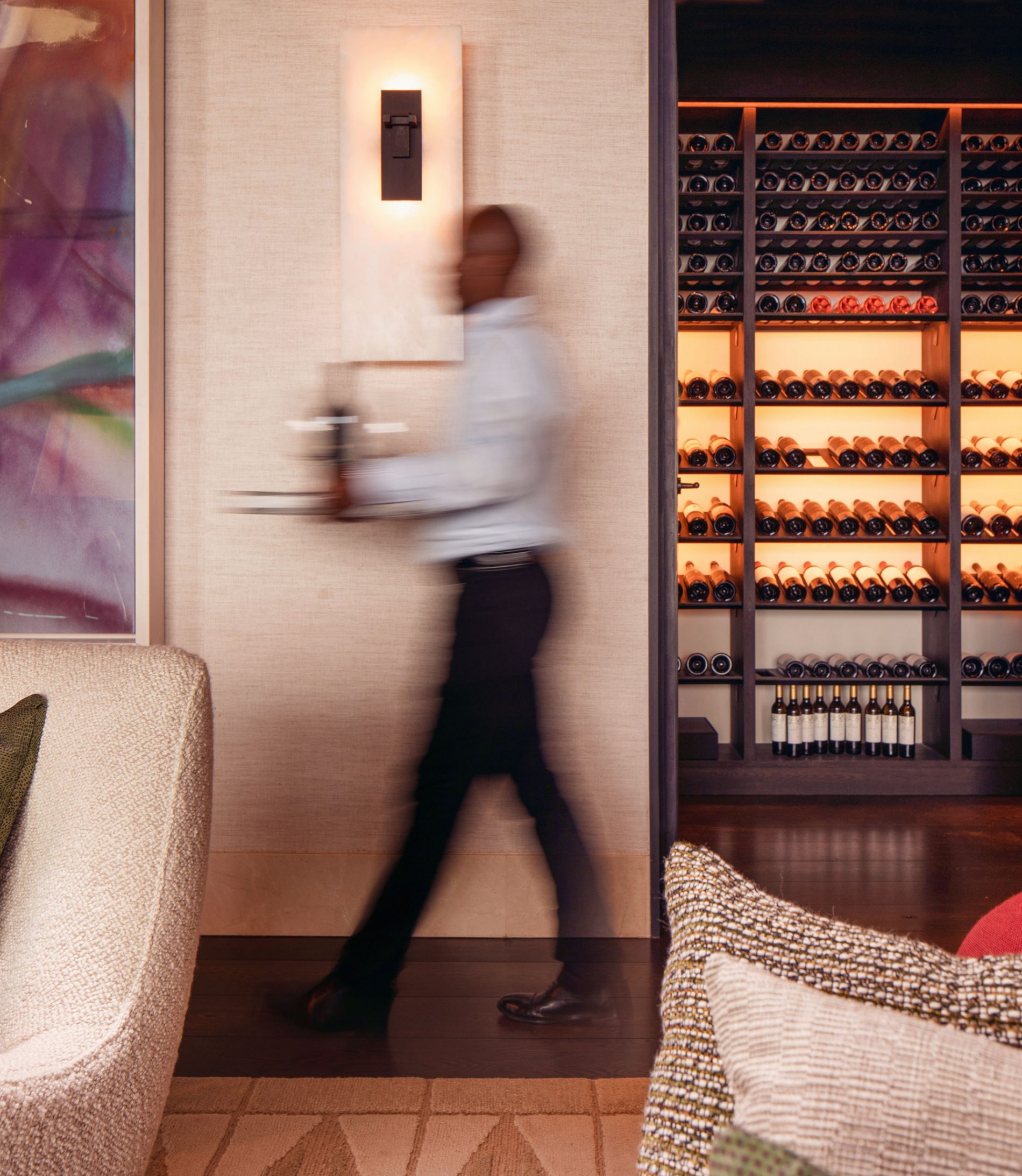 A private butler carrying wine in the Owner's Villa