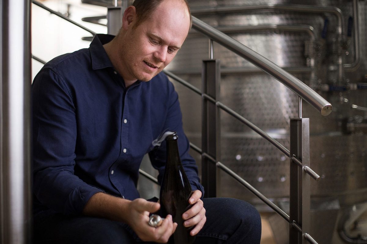 Morne Vrey sitting on Delaire Graff Estate winery steps