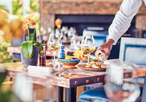 A waiter serving a table at Indochine Restaurant