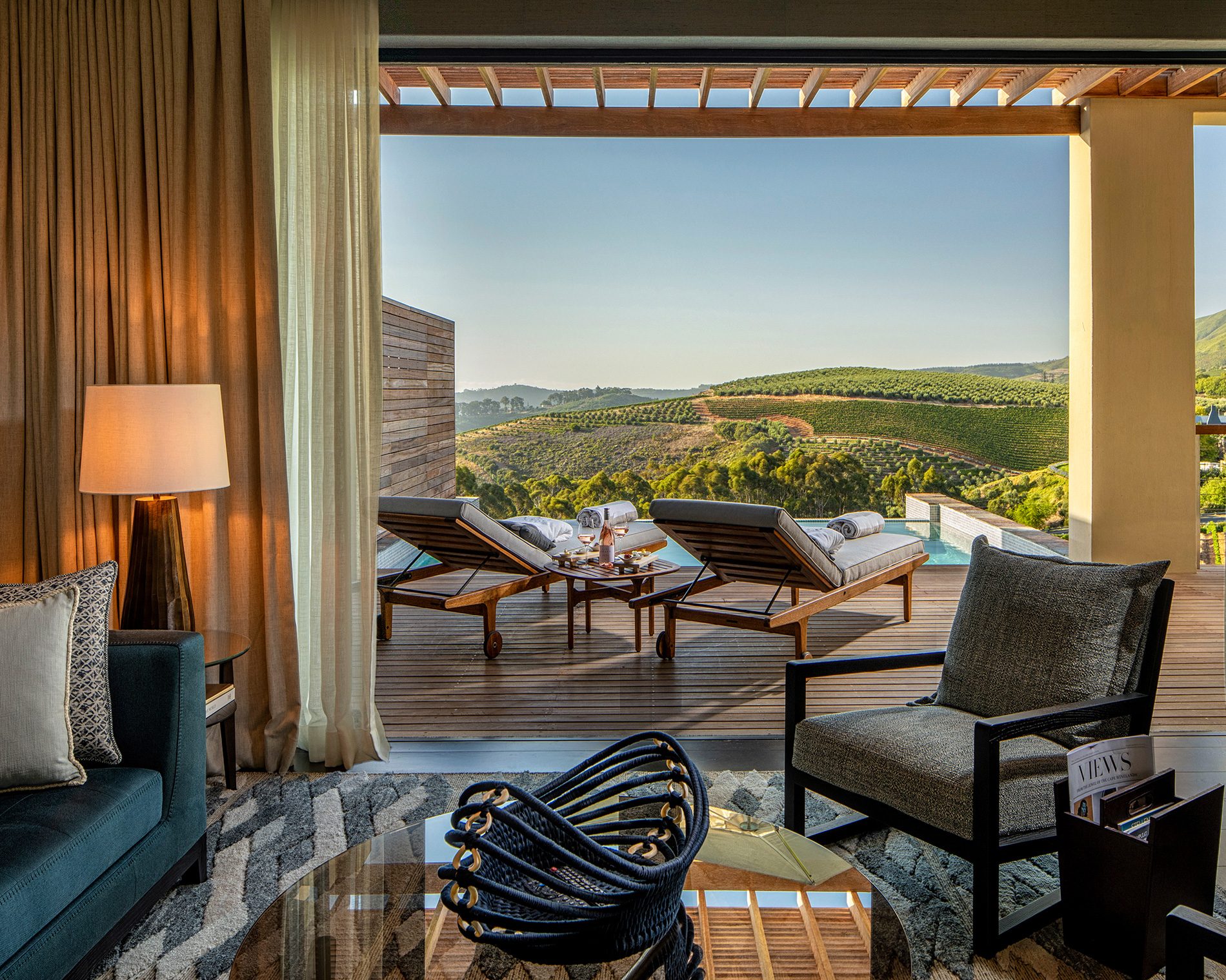View from a Superior Lodge living room towards the terrace and plunge pool with views towards False Bay and Stellenbosch vineyards