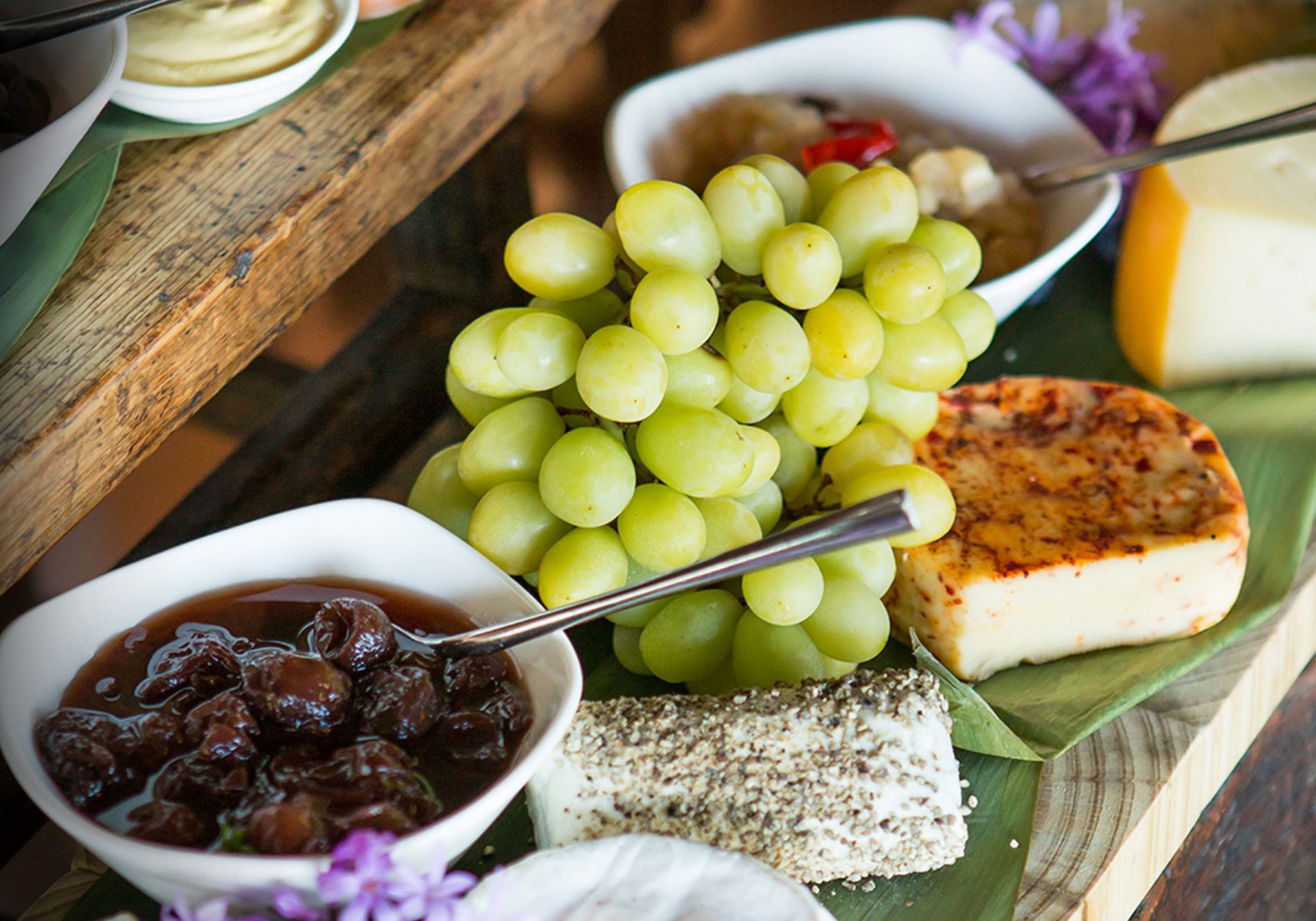 A platter of cheese and grapes