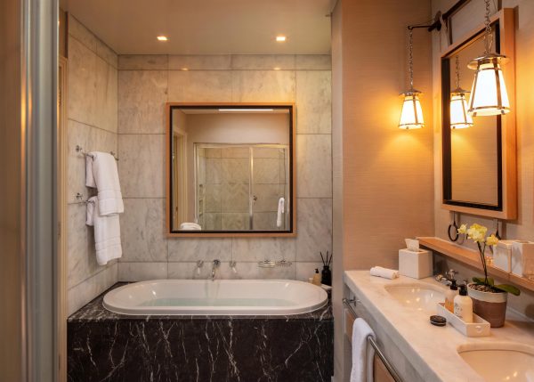Deluxe Lodge bathroom with bat tub and vanity at Delaire Graff Estate