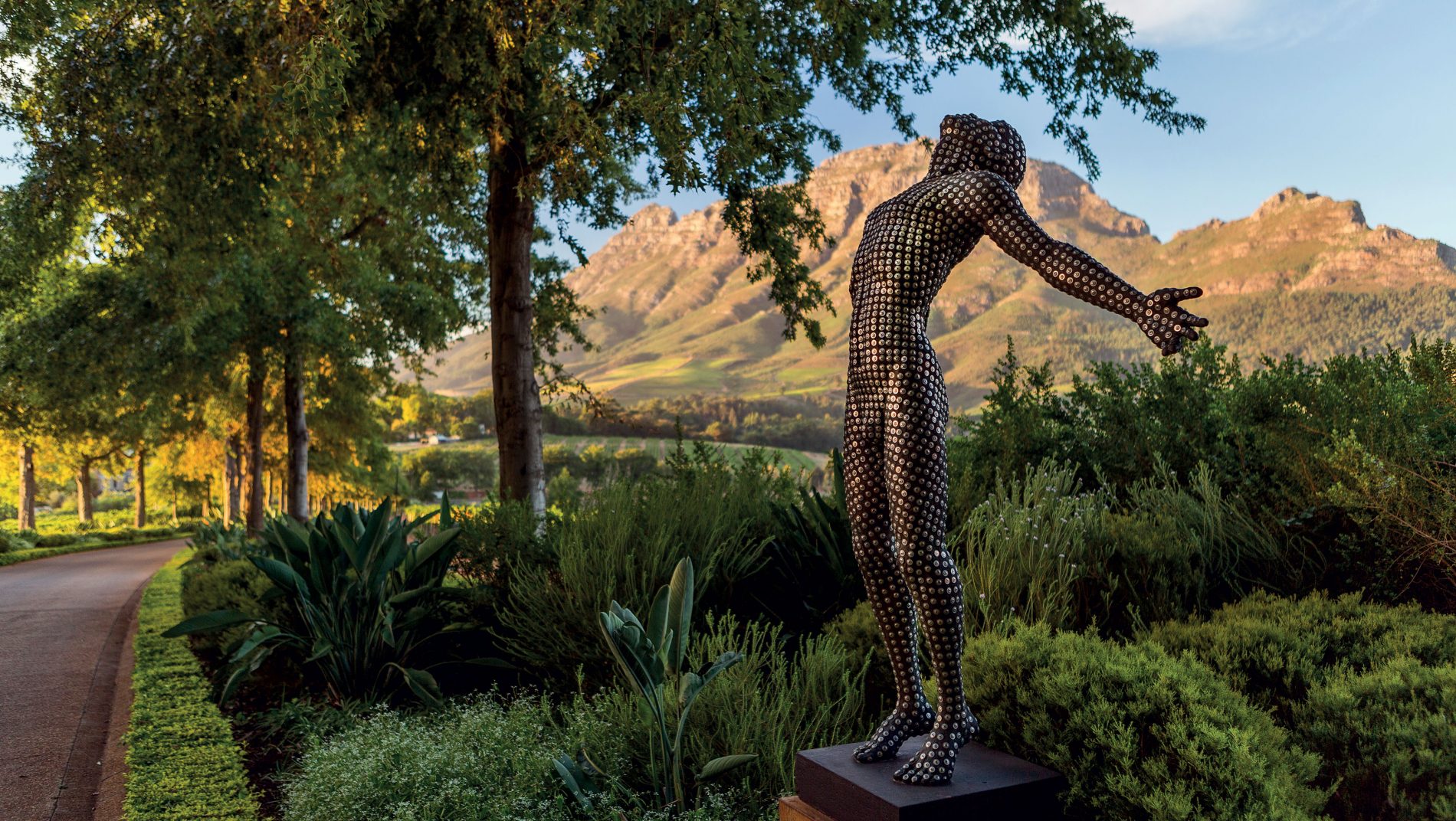 A Dylan Lewis sculpture of a man on the Delaire Graff Estate driveway