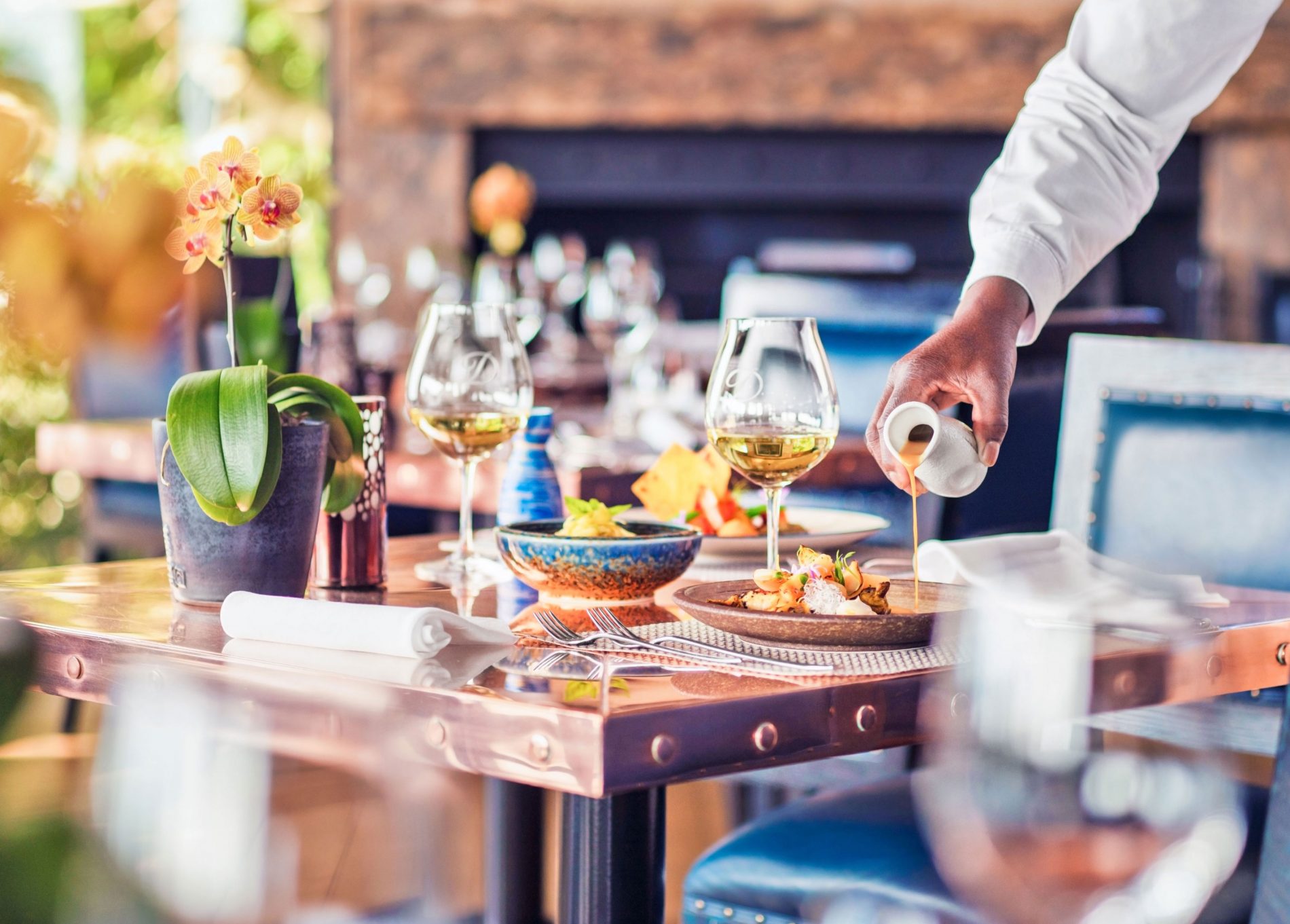 A waiter serving a dish at Indochine