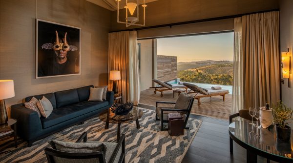 Superior Lodge living room leading onto terrace and plunge pool at Delaire Graff Estate