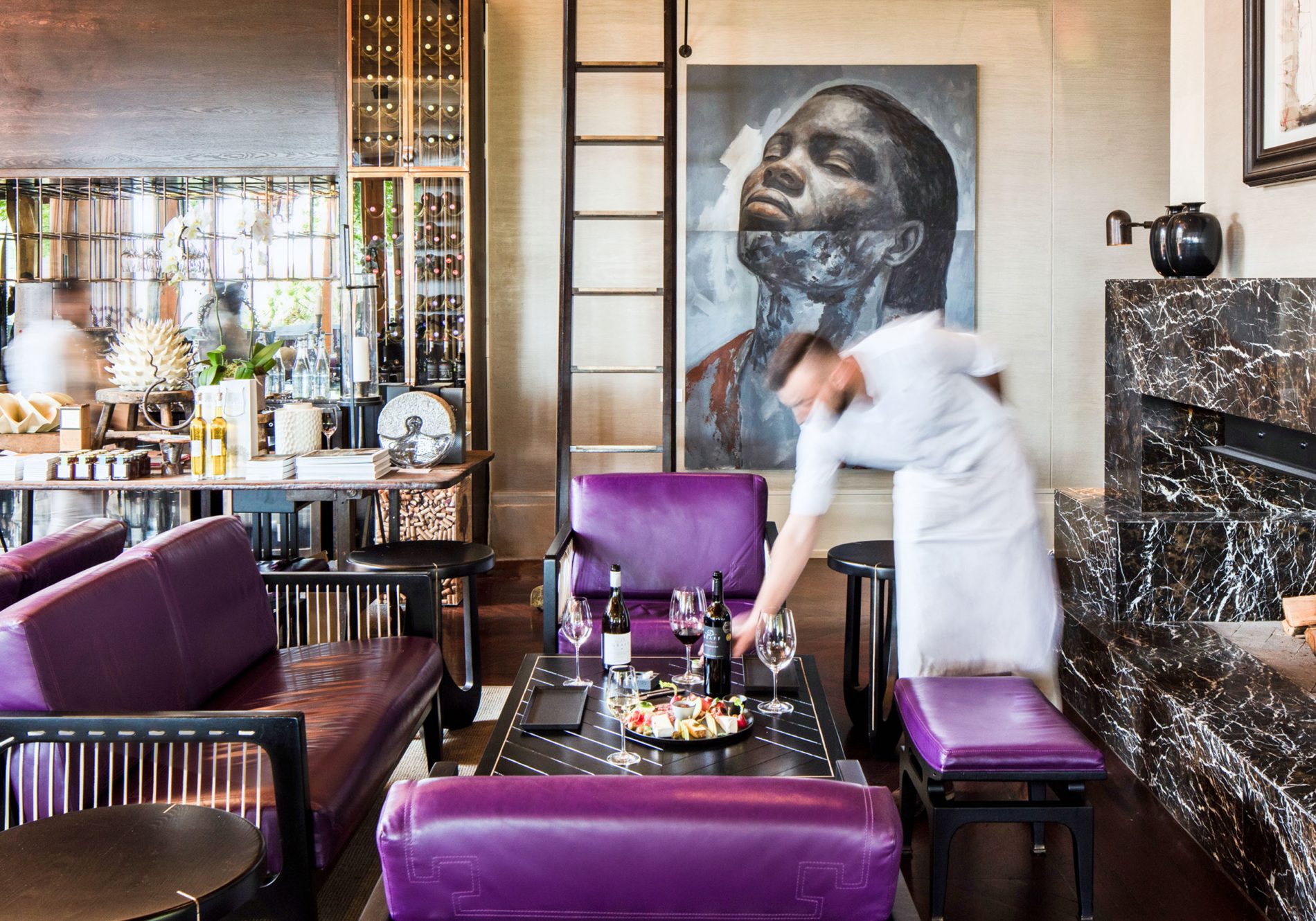 A waiter placing a sharing platter in the Wine Lounge