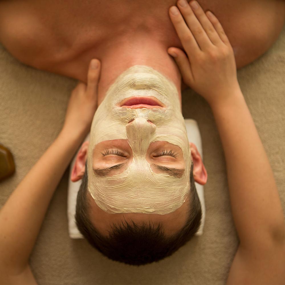 a gentleman having a face mask treatment