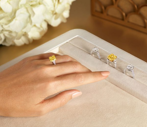 a lady wearing a yellow radiant cut Graff diamond on her finger