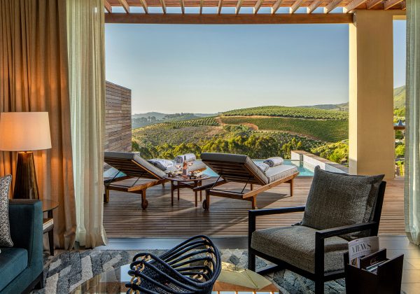 a superior lodge living room at Delaire Graff Estate leading onto terrace and private plunge pool with views over Stellenbosch vineyards