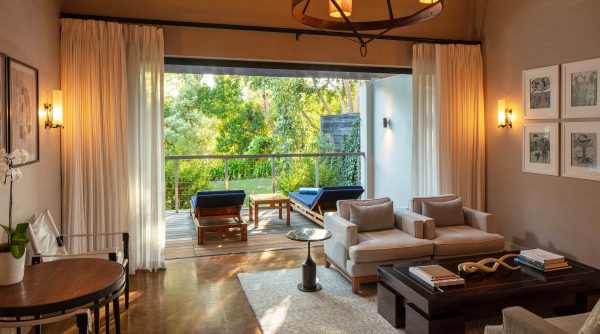 Deluxe Lodge living room leading onto terrace overlooking Delaire Graff Estate gardens